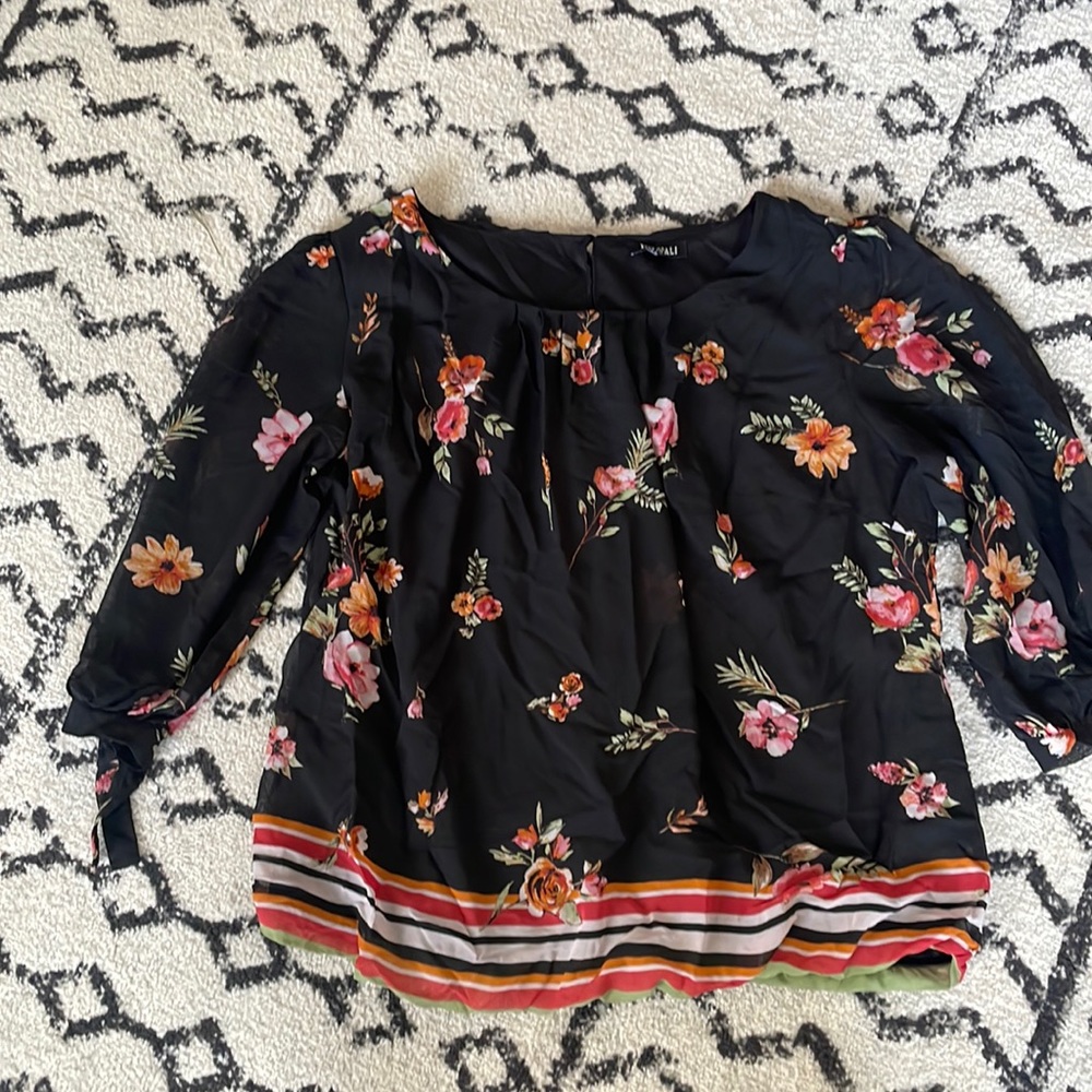 Black dressy floral top with elastic at bottom of shirt.